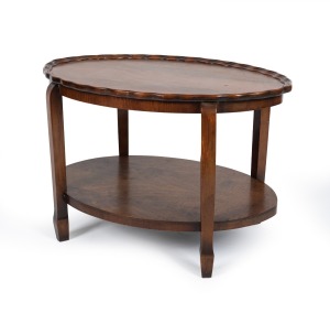 A vintage two tier oval occasional table with pie-crust top, 20th century, ​​​​​​​45cm high, 68cm wide, 47cm deep.