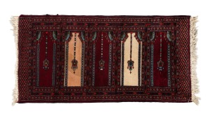 A Persian hand-knotted wool prayer rug on burgundy ground, 125 x 60cm.