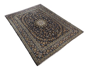 A Persian hand-knotted wool rug on blue ground. Note: Fringe reduced. An impressive 412 x 305cm.