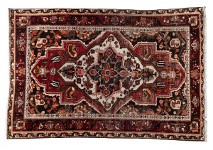 A vintage hand-knotted Persian rug on burgundy and red ground. Note: Very worn. ​​​​​​​310 x 205cm.