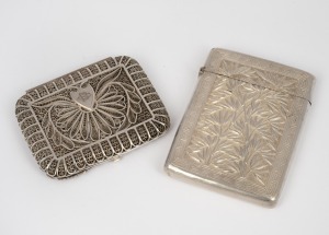An antique silver filigree cigarette case, possibly Russian; together with a Chinese export silver cigarette case (Note: Missing hinge pin), 19th/20th century, (2 items), the larger 9.5cm high, 142 grams total.