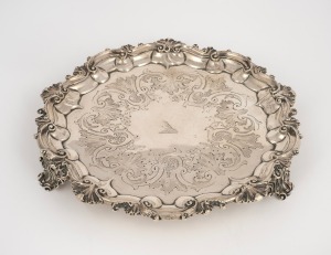 An antique English sterling silver salver with Rococo revival scrolling feet and engraved bird crest, made in London, circa 1846, 21cm wide, 344 grams.