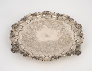 An antique English sterling silver salver with Rococo revival scrolling feet and engraved bird crest, made in London, circa 1846, 21cm wide, 344 grams.