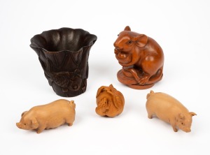An antique Chinese bamboo libation cup; together with two carved wooden pig ornaments, a carved timber netsuke with rat decoration and a carved timber rat ornament, (5 items), the cup 8.5cm high.