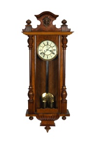 An antique Vienna regulator with twin train weight driven movement, striking on a gong with two-piece enamel dial and walnut case, circa 1880, 121cm high.