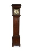 An antique English oak longcase clock by GEORGE HEWETT of Marlborough with engraved silvered dial, early 19th century, 205cm high.