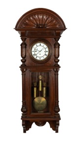 An antique German wall clock in carved walnut case with associated Viennese Grand Sonnerie three train movement and two piece enamel dial with carved pie crust surround, circa 1900, 120cm high, 49cm wide, 20cm deep.
