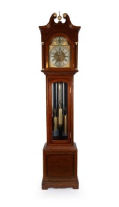 An antique English Sheraton revival longcase clock in mahogany case with glazed trunk door displaying brass weights, pendulum and nickel plated gong tubes. The hood with swan neck pediment, brass ball and spire finial and Corinthian capitals to the pillar