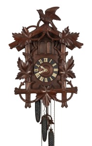 BLACK FOREST antique German cuckoo three weight wall clock, sounding the cuckoo and gong on the half hour and hour with additional music box on the hour. Stained fruitwood and bass wood chalet style case with vine leaf and carved cuckoo decoration, circa 