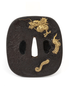 An antique Japanese bronze tsuba with dragon decoration in gilt highlights, Meiji period 19th century, 9 x 8cm