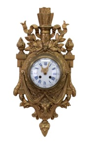 An antique French Cartel clock in gilt metal case with ram's head decoration, eight day time and strike movement with Roman numerals under convex glass, 19th century, note: later painted gold finish. ​​​​​​​53cm high.