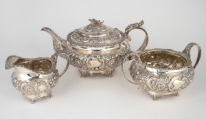 A Georgian three piece English sterling silver tea service with repousse floral decoration, stamped "G.H.", made in London, circa 1823, the tea pot 14cm high, 27cm wide, 1290 grams total.