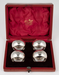 A set of four antique English sterling silver napkin rings housed in original scarlet leather plush fitted retailer's box, made in Sheffield, circa 1907, ​​​​​​​the box 14cm wide, 66 grams total.