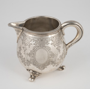 An antique English sterling silver cream jug with engraved decoration and finely beaded edge, made for the Goldsmiths Alliance of Cornhill, London, circa 1883, 8cm high, 158 grams.