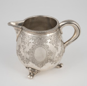 An antique English sterling silver cream jug with engraved decoration and finely beaded edge, made for the Goldsmiths Alliance of Cornhill, London, circa 1883, 8cm high, 158 grams.
