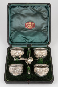 An antique English boxed set of four sterling silver salt cellars with sterling silver spoons, by Colen Cheshire of Birmingham, circa 1891, the box 17cm wide, 184 grams total.