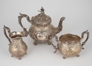 A vintage English sterling silver three piece tea service with floral decoration and bird finial, made in Sheffield, 20th century, the teapot 21cm high, 1,485 grams total.