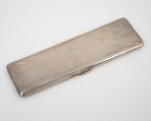 An antique sterling silver cigarette case with engine turned decoration and gilt wash finish to the interior, made in Birmingham, 20th century, elegant and unusually long form 17cm wide, 122 grams.