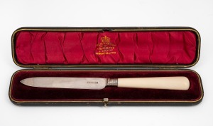 An antique English sterling silver cake knife with ivory handle, housed in original plush fitted box, by Atkin Bros. of Sheffield, circa 1902, 24cm long.