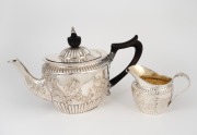 An antique English sterling silver teapot with ebonized timber handle and finial; together with a matching milk jug, made by John Newton Mappin of London, circa 1897, (2 items), 13cm high, 24cm wide, 517 grams total (including handle and finial).