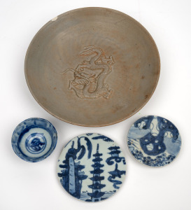 An antique Chinese Longquan celadon relief moulded dragon bowl, Ming Dynasty, 16th century; together with two 18th century blue and white stands and a small bowl, (4 items), the largest 21cm diameter.