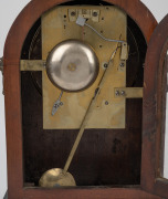 An antique English mahogany arch top spring table clock with ebony banding and brass inlay, convex painted dial with Roman numerals, minute track and cast brass bezel. Signed "Jms. Martin, Bath". Eight day two train fusee movement striking the hours on a - 3