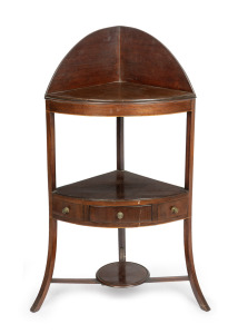 A Georgian mahogany corner washstand with sabre legs, circa 1800, 102cm high, 53cm wide, 39cm deep.