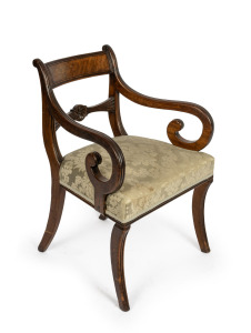 An antique English mahogany spade back carver chair with sabre legs and finely carved back rail, early 19th century, 55cm across the arms.