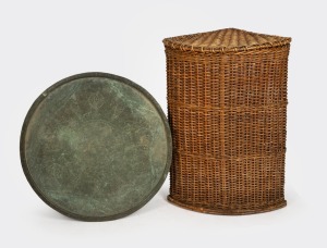 An antique Islamic copper tray; together with a vintage cane corner laundry hamper, (2 items), the tray 78cm diameter and the basket 90cm high, 63cm wide, 51cm deep.