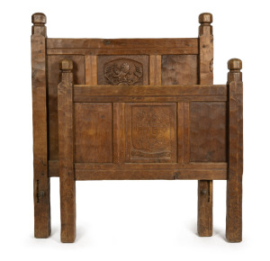MOUSEMAN English ash single bed ends, carved with armorial crest (CLEGG FAMILY) and Robert "Mouseman" Thompson's carved mouse signature running up the side of the head, 20th century. (Note: No slats or rails). The bed head 115cm high, 91cm wide.