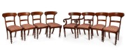 A set of eight antique mahogany spade back dining chairs, comprising of six standards with carved capitals and two carvers without, mid 19th century.
