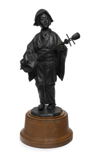 An antique Japanese cast bronze statue of a female musician standing on later turned wooden plinth, Meiji period, 19th century, the statue 37cm, 47cm high overall.