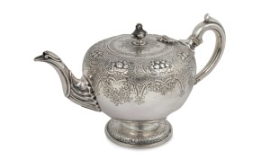 An antique Scottish sterling silver teapot with engraved floral motif and fruit decoration, made in Edinburgh, circa 1853, 18cm high, 29cm wide, 724 grams.