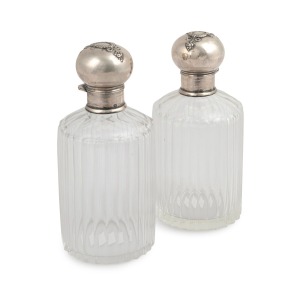 A pair of antique sterling silver mounted crystal scent bottles, late 19th century, ​​​​​​​14.5cm high.