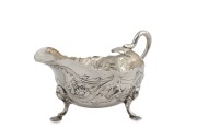 A Georgian silver Rococo sauce boat with snake handle, most likely Channel Islands, mid 18th century, stamped "H.W.", and engraved with ownership monogram "W.E.M.", ​​​​​​​9cm high, 15cm wide, 200 grams.