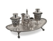 An antique Anglo-Indian 800 silver desk set with original blue glass liners, 19th century, 30cm wide, 1312 grams (not including liners).