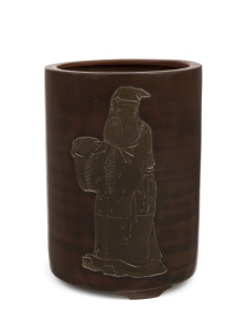 A Chinese brown glazed terracotta brush pot with intaglio decorated figure of Shoulao (God of Longevity), Qing Dynasty, 19th century, square seal mark to base, 13cm high.