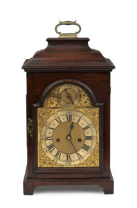 An antique English provincial mahogany spring table clock with inverted bell top case, break arch brass dial with strike silent subsidiary and two train time and bell striking movement. The brass back plate engraved "LEWIS THOMAS, CHESTER", circa 1860. Note: The movement now lacking pull quarter repeat mechanism and escapement later converted to recoil. 50cm high.
