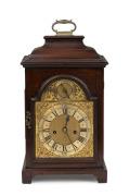 An antique English provincial mahogany spring table clock with inverted bell top case, break arch brass dial with strike silent subsidiary and two train time and bell striking movement. The brass back plate engraved "LEWIS THOMAS, CHESTER", circa 1860. No