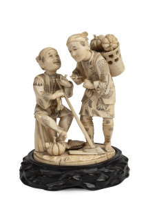 A Japanese okimono figural group of two farmers smoking pipes, on carved wooden base, Meiji Period, 19th/20th century, 20cm high overall including base.