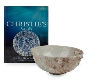 BINH THUAN Chinese porcelain shipwreck bowl, Ming Dynasty, circa 1610, decorated with Buddhistic lion chasing a brocade ball within a double line circle, heavily encrusted with seashells and bearing original Christie's label "Binh Thuan Shipwreck, 44613",
