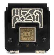 A.W.A. THE FISK RADIOLETTE "Fret and Feet" mantle radio in black and mottled white bakelite, 33cm high.
