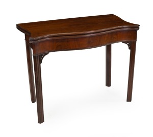 An antique English Chippendale period serpentine fronted mahogany card table with wool lined gaming surface and concertina action support, circa 1770, 74cm high, 94cm wide, 47cm deep.