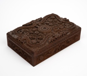 An antique Indian sandalwood box, profusely carved with floral decoration, 19th century, 9cm high, 31cm wide, 20cm deep.
