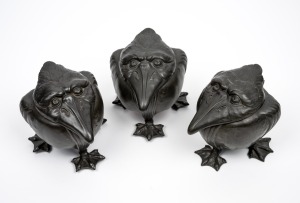 A rare set of three pewter grotesque bird jars with coloured porcelain linings, 19th/20th century, 11cm high.