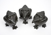 A rare set of three pewter grotesque bird jars with coloured porcelain linings, 19th/20th century, 11cm high.