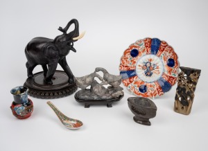 Carved soapstone ornaments, Imari plate, famille rose porcelain spoon, carved wooden stand, Sumida Gawa vase (damaged) and a cast resin elephant statue, 20th century (7 items), the plate 21.5cm wide