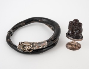A Chinese carved amber and silver seal; together with a Chinese black coral bangle with silver dragon decoration, 20th century, (2 items).