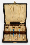 A set of six Danish sterling silver and enamel coffee spoons with gilt wash finish, housed in a fitted box, 20th century, ​​​​​​​9.5cm long, 60 grams total.