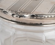A beautiful pair of antique sterling silver and enamel topped crystal vanity jars with fine wheel cut floral decoration, early 20th century, stamped "STERLING SILVER, HAND HAMMERED", ​​​​​​​7.5cm high, 12.5cm wide, 154 grams silver weight (not including c - 2